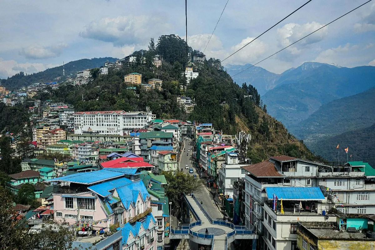 Brightly painted buildings of Gangtok packed along a ridge above the valley