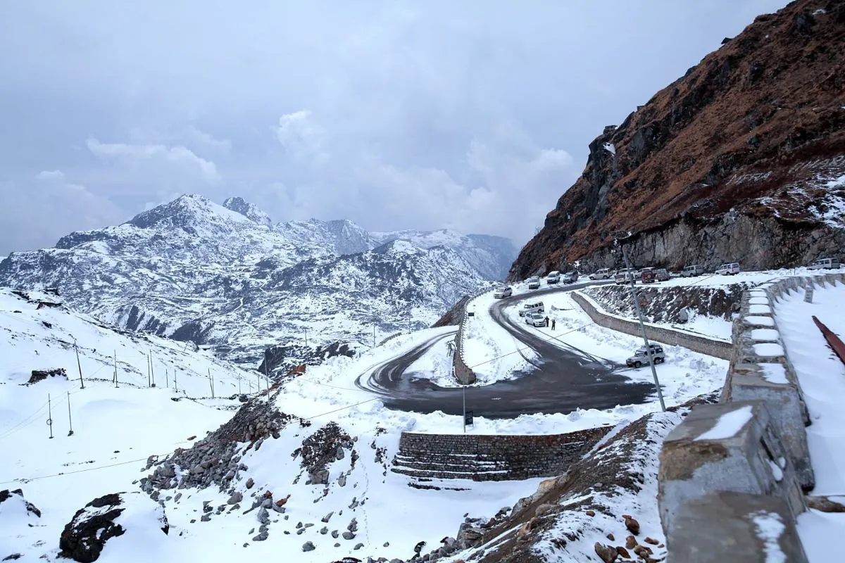 The switchback road climbing through deep snow on the approach to Nathu La