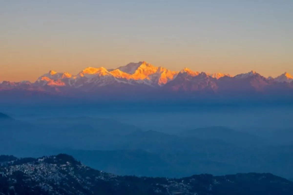 Travel to Sikkim – sunrise over the Kangchenjunga range above a sea of cloud